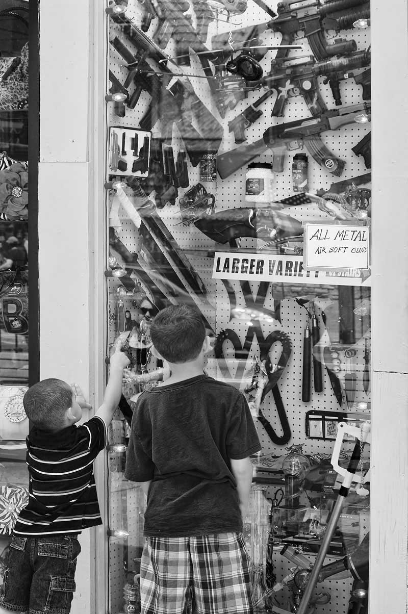 Children looking at guns